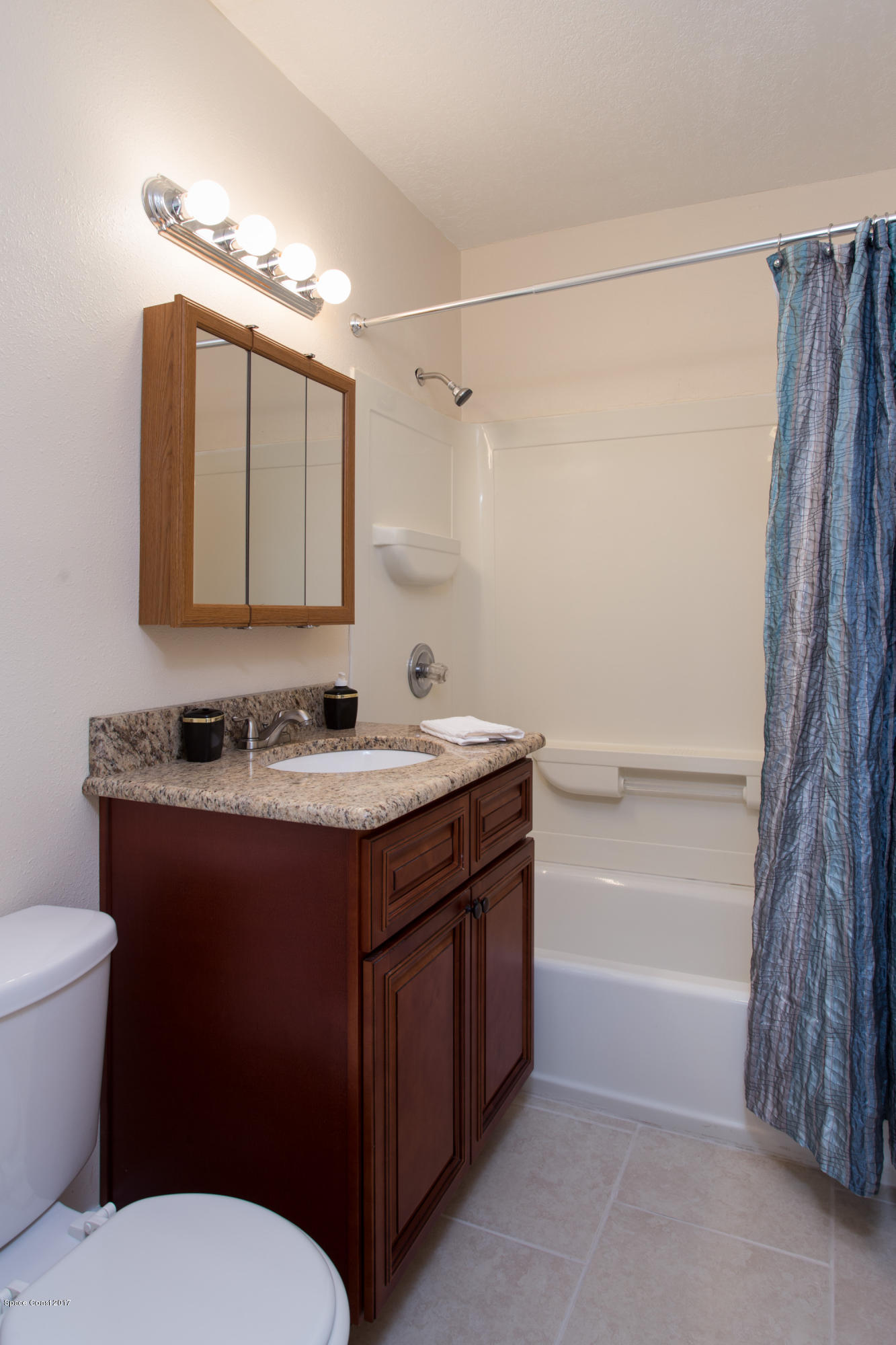 318 West Rutgers Street Melbourne, FL 32901 - Photo 12 of 14 a bathroom with a sink toilet and shower