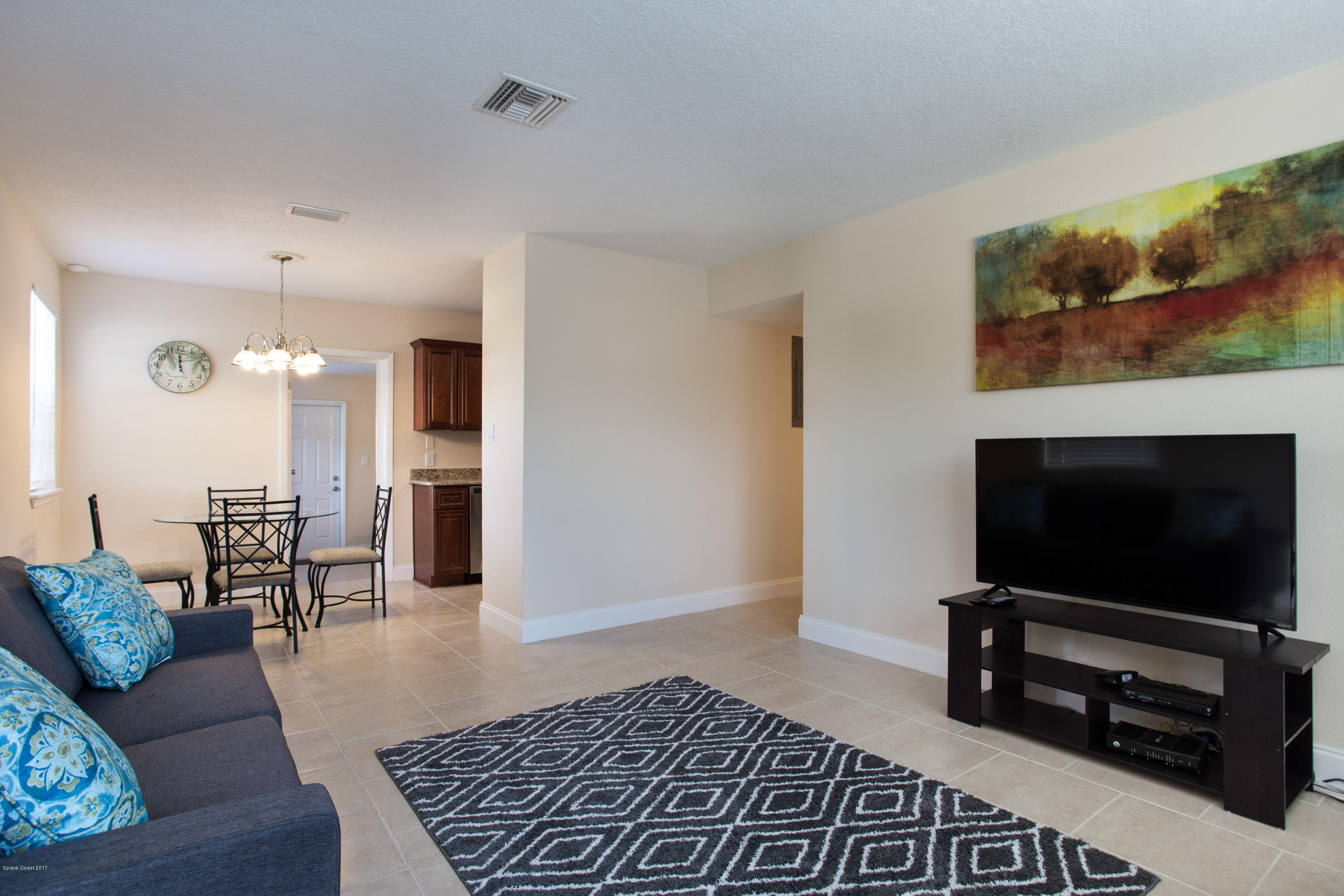 318 West Rutgers Street Melbourne, FL 32901 - Photo 4 of 14 a living room with furniture and a flat screen tv
