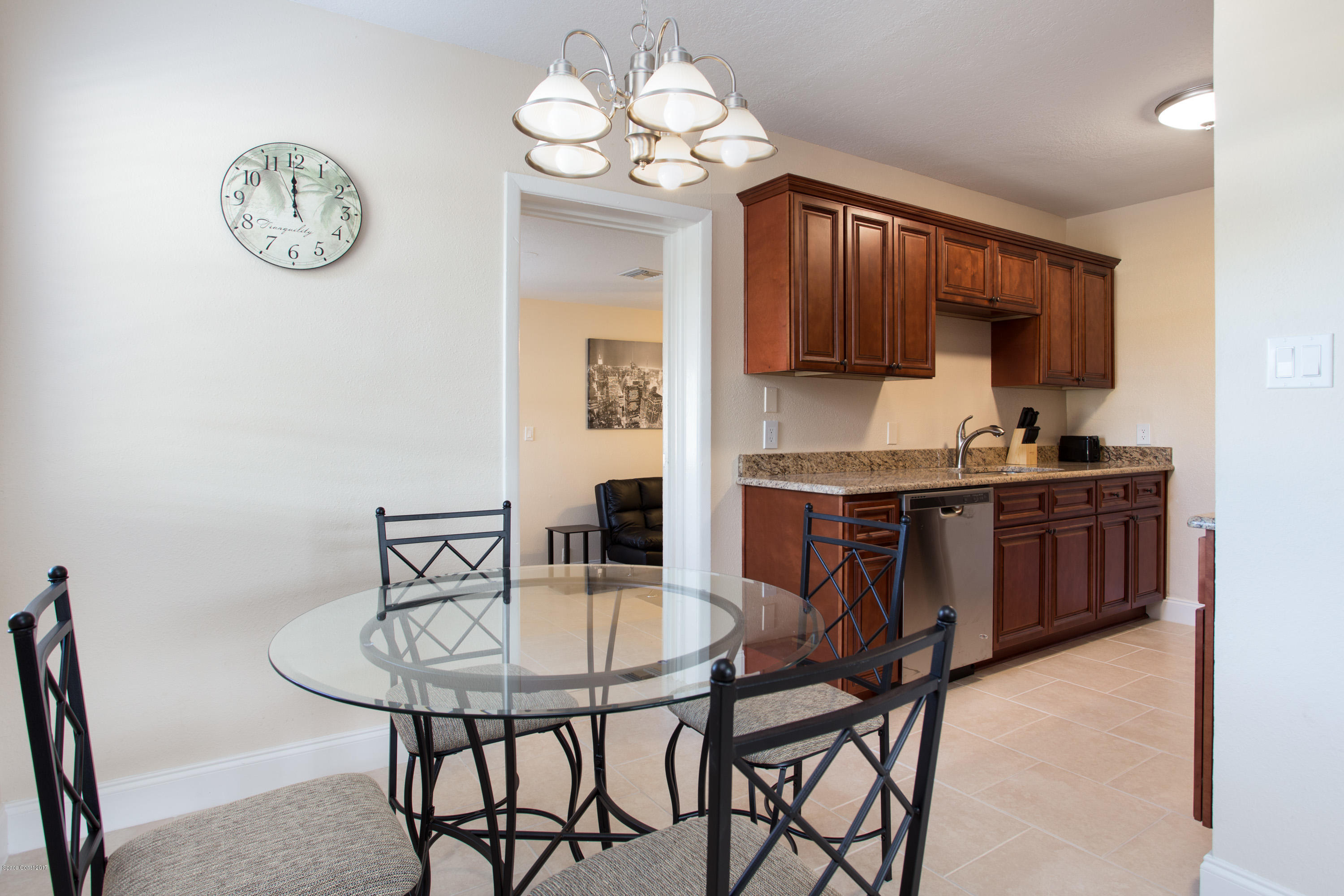 318 West Rutgers Street Melbourne, FL 32901 - Photo 5 of 14 a kitchen with a dining table and chairs