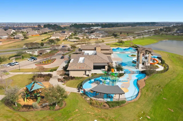 a view of a swimming pool with an ocean and trees in the background