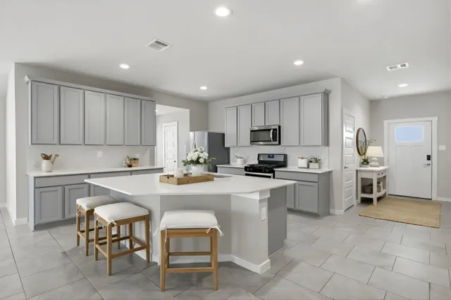 a kitchen with cabinets stainless steel appliances and a counter top space