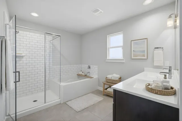 a bathroom with a tub sink and mirror