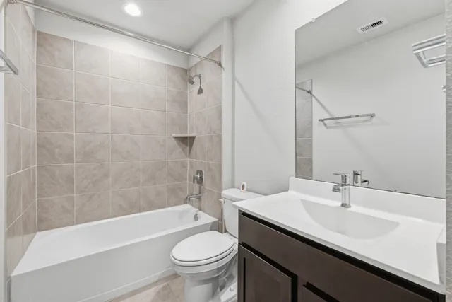 a bathroom with a sink a toilet and bathtub