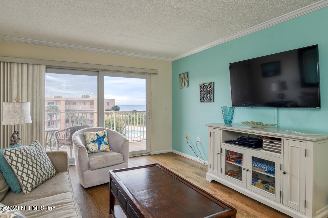 4 Ocean Trace Road, Unit 405 St. Augustine, FL 32080 - Photo 3 of 27 a living room with furniture and a flat screen tv