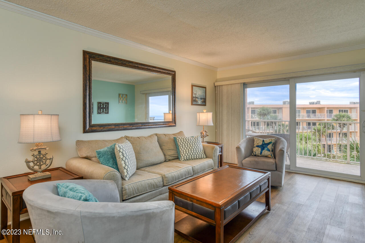 4 Ocean Trace Road, Unit 405 St. Augustine, FL 32080 - Photo 4 of 27 a living room with furniture and a large window