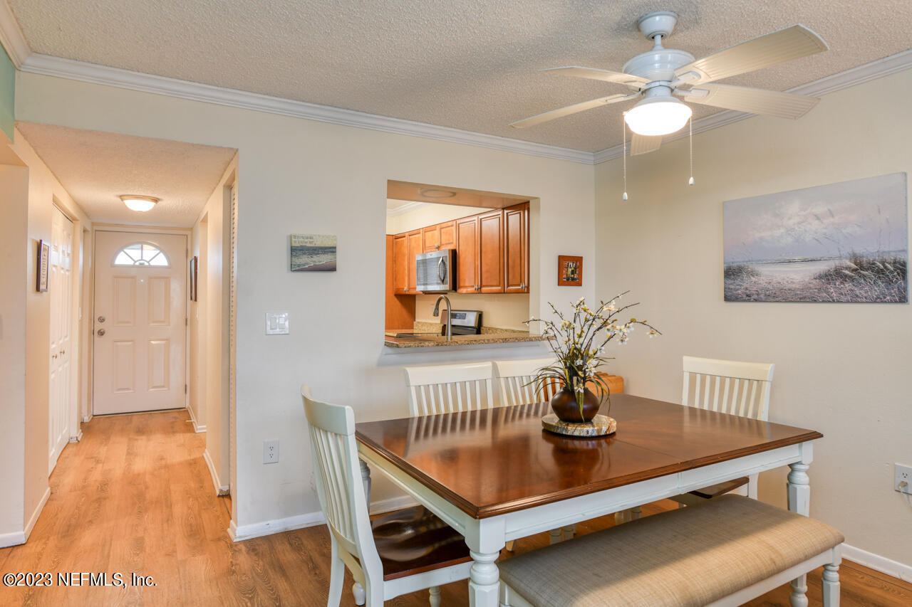4 Ocean Trace Road, Unit 405 St. Augustine, FL 32080 - Photo 6 of 27 a view of a dining room with furniture and wooden floor