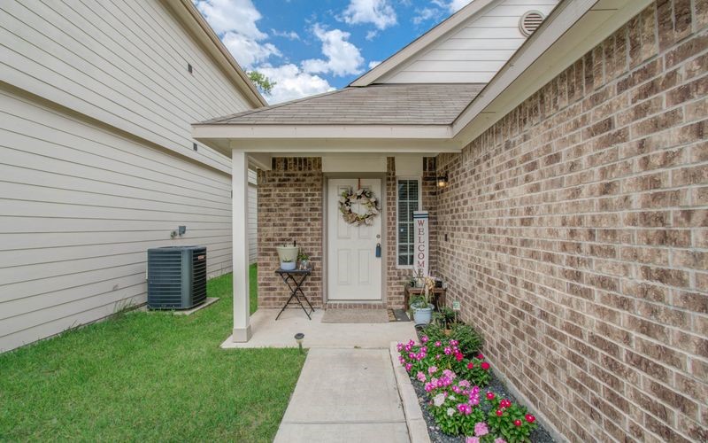 25416 Grotto Falls Lane Porter, TX 77365 - Photo 2 of 15 a front view of a house with garden