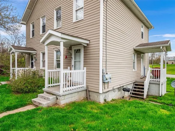 a front view of a house with a garden