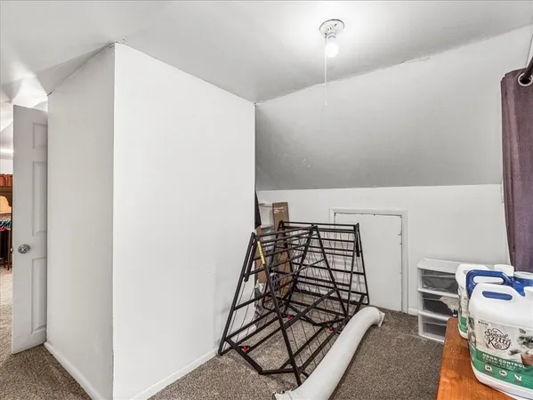 a view of a bedroom with bed and closet