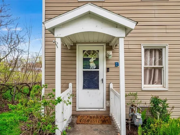 a view of a house with potted plants