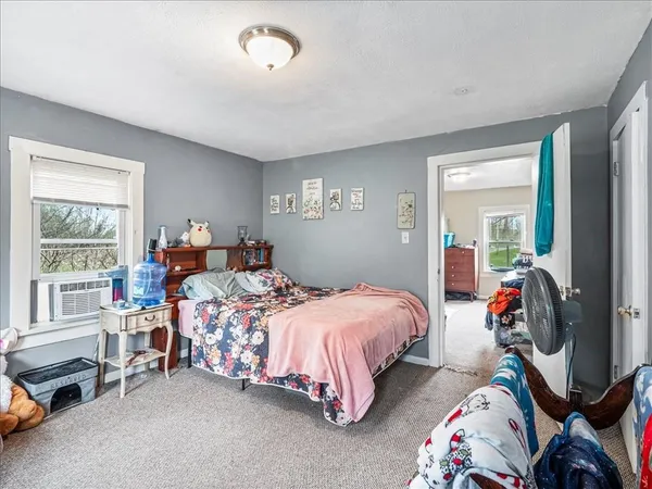 a bedroom with bed and a window