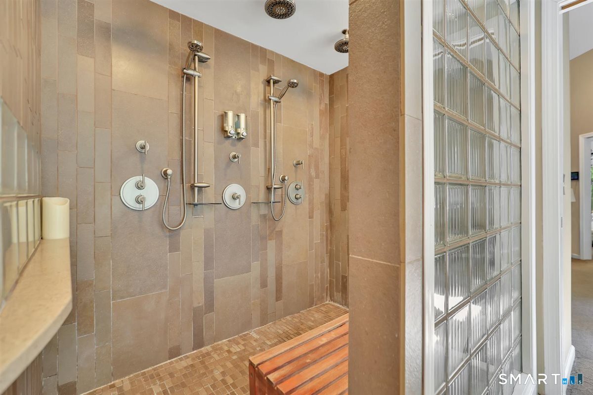 122 Ridgeview Circle Guilford, CT 06437 - Photo 14 of 40 Master bath offers an easy access large walk-in shower with three rain-heads, tile and glass surround, for the ultimate shower experience.
