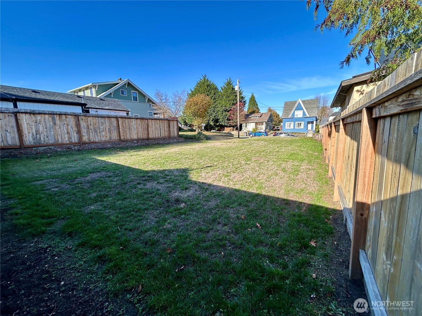 1241 8th Street Bremerton, WA 98337 - Photo 5 of 15 a view of a house with a big yard and large trees