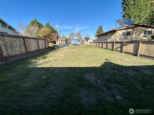 a view of a backyard with swimming pool