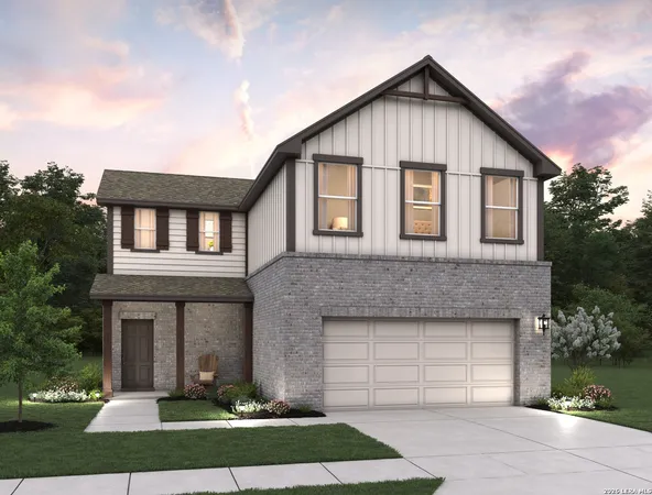 a front view of a house with a garden and garage