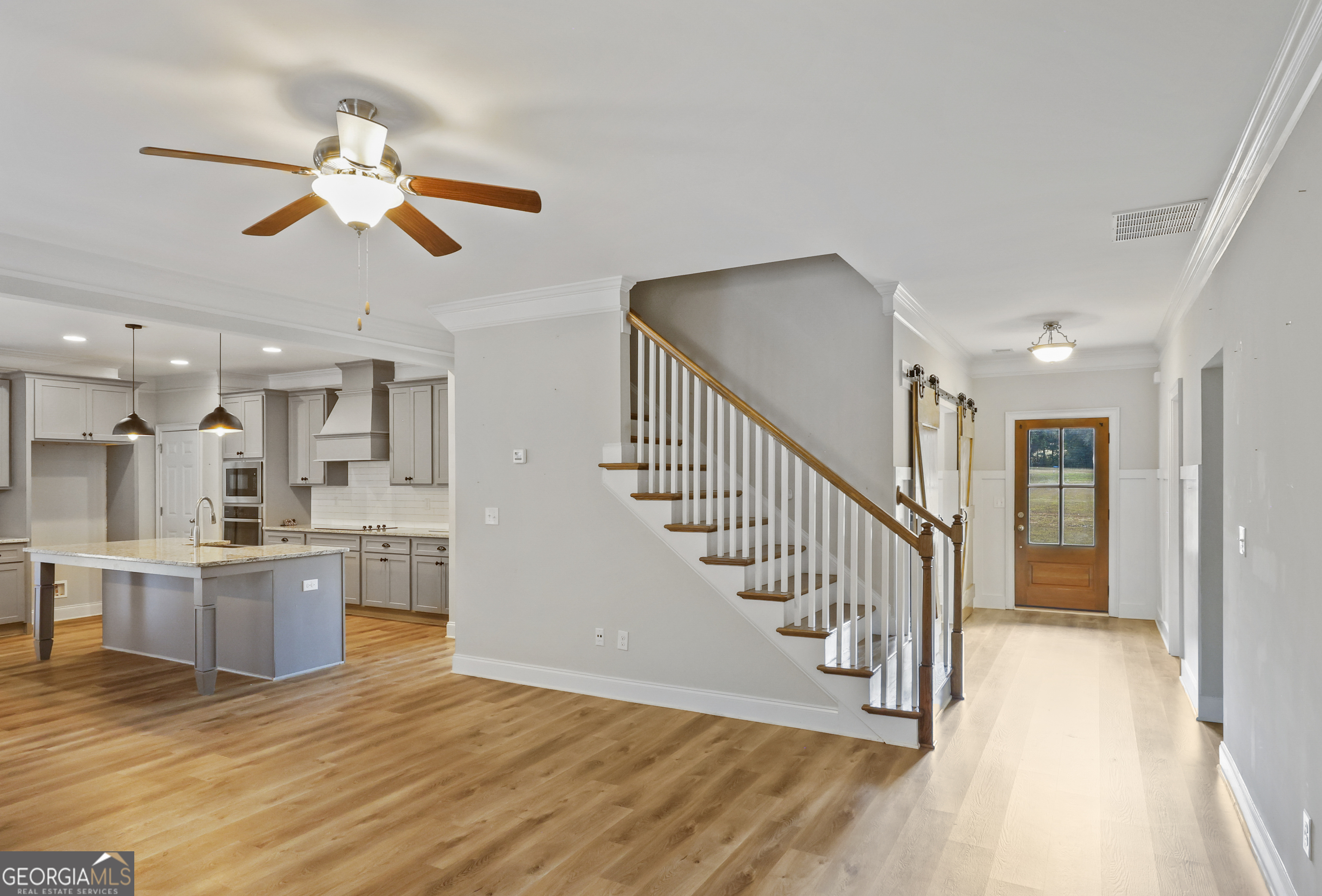 563 Wynn Road McDonough, GA 30252 - Photo 12 of 47 a view of a hallway with wooden floor and a kitchen