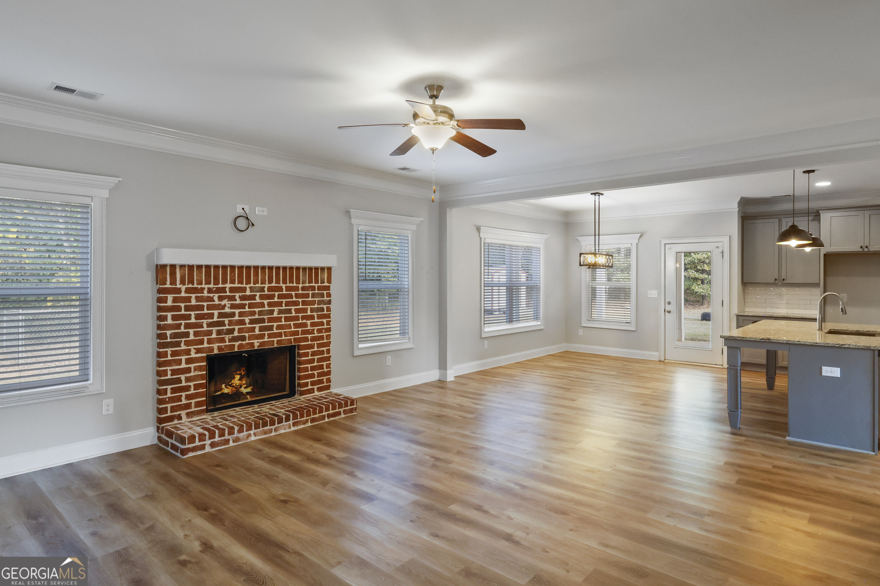 563 Wynn Road McDonough, GA 30252 - Photo 13 of 47 a view of an empty room with wooden floor fireplace and a window