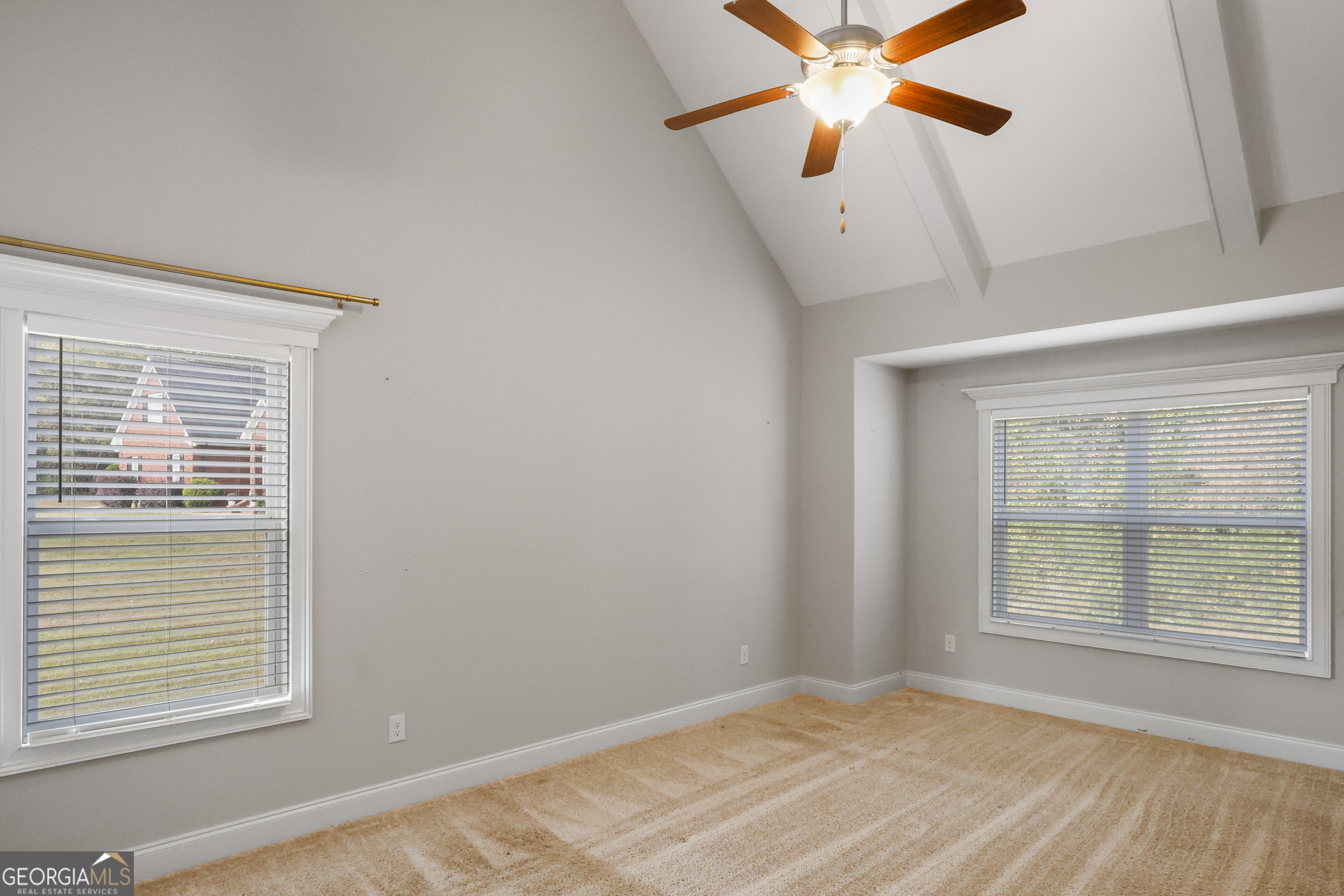 563 Wynn Road McDonough, GA 30252 - Photo 17 of 47 a view of a bedroom with a window and a ceiling fan