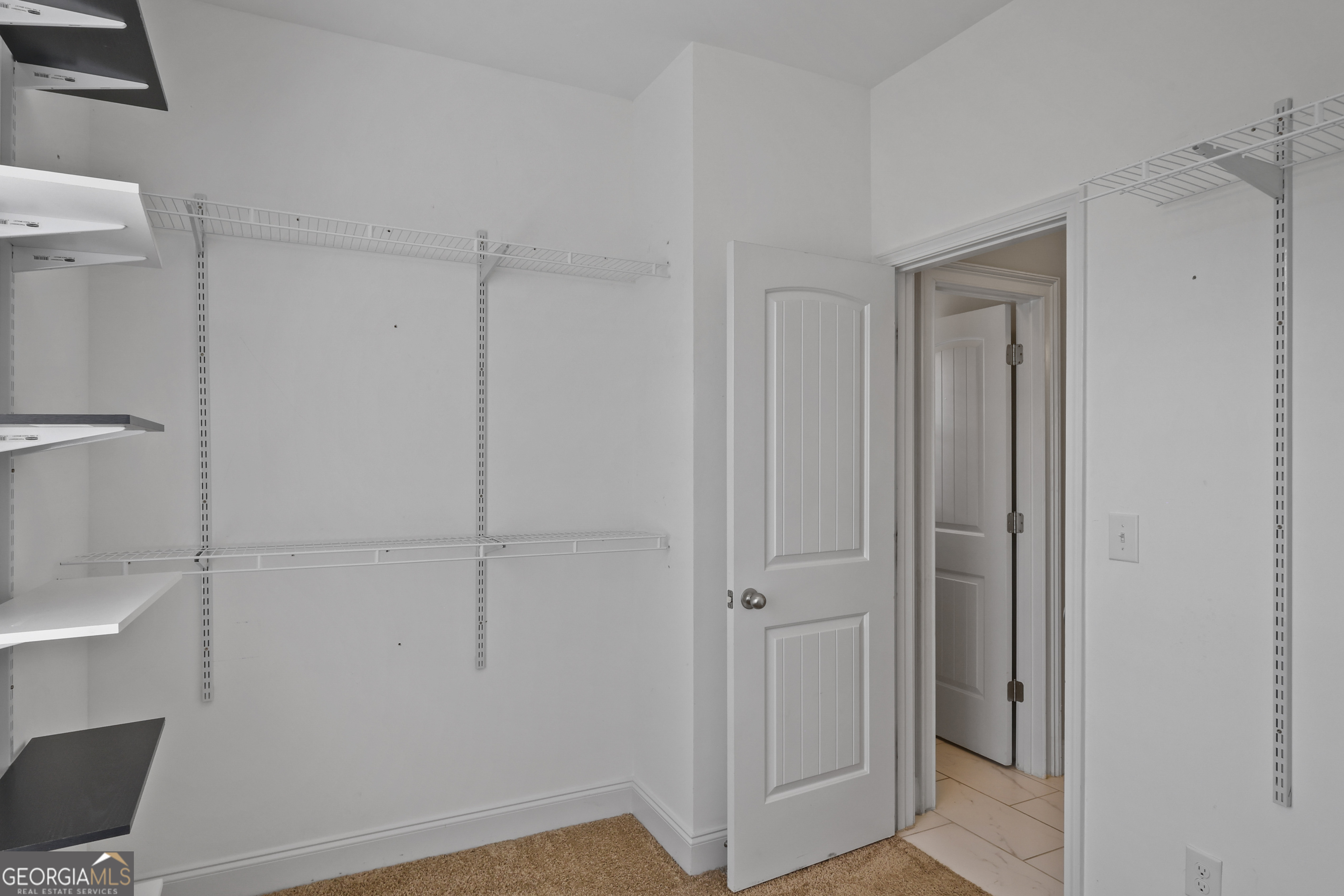 563 Wynn Road McDonough, GA 30252 - Photo 24 of 47 a view of a closet area with empty racks