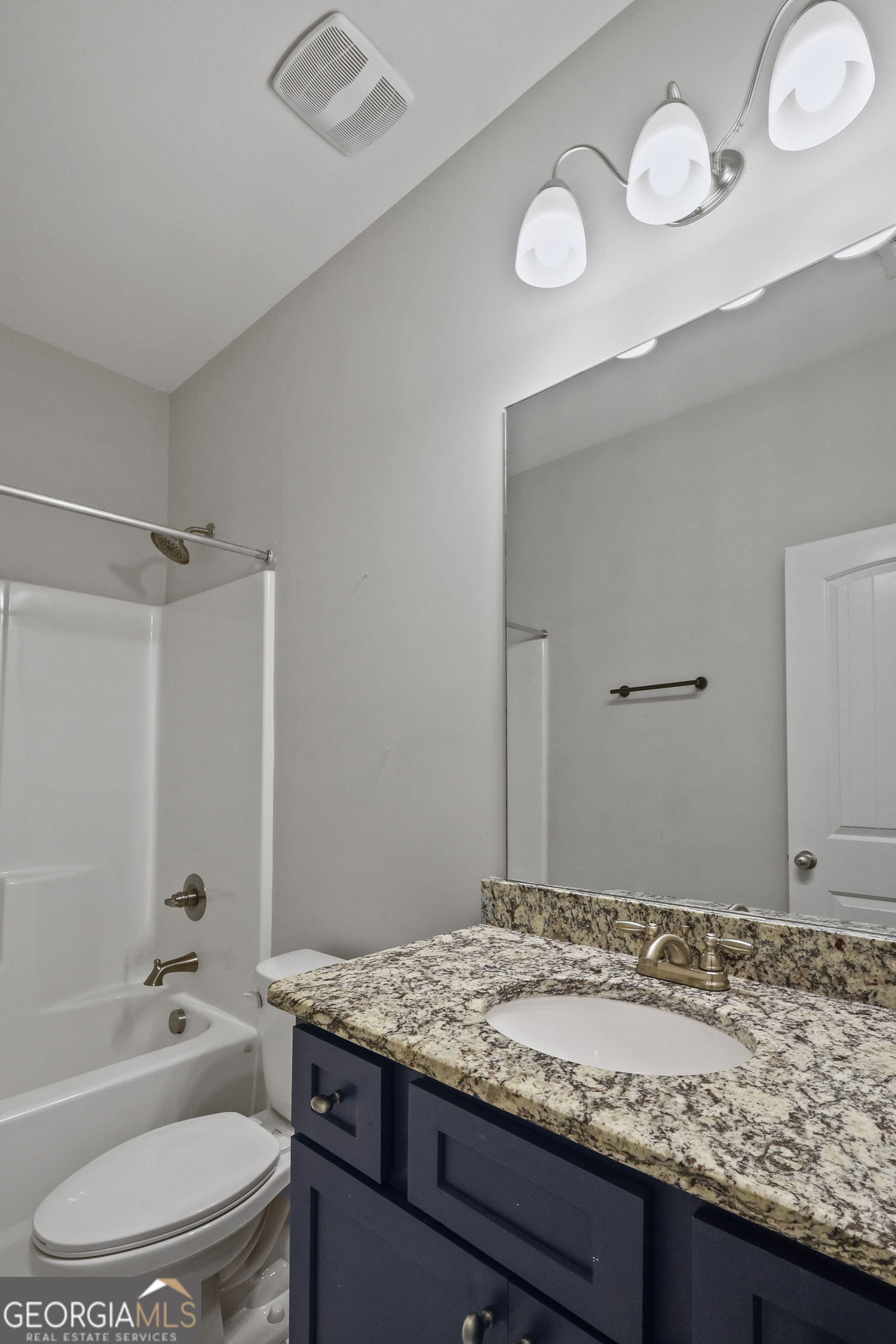 563 Wynn Road McDonough, GA 30252 - Photo 37 of 47 a bathroom with a granite countertop sink toilet and mirror
