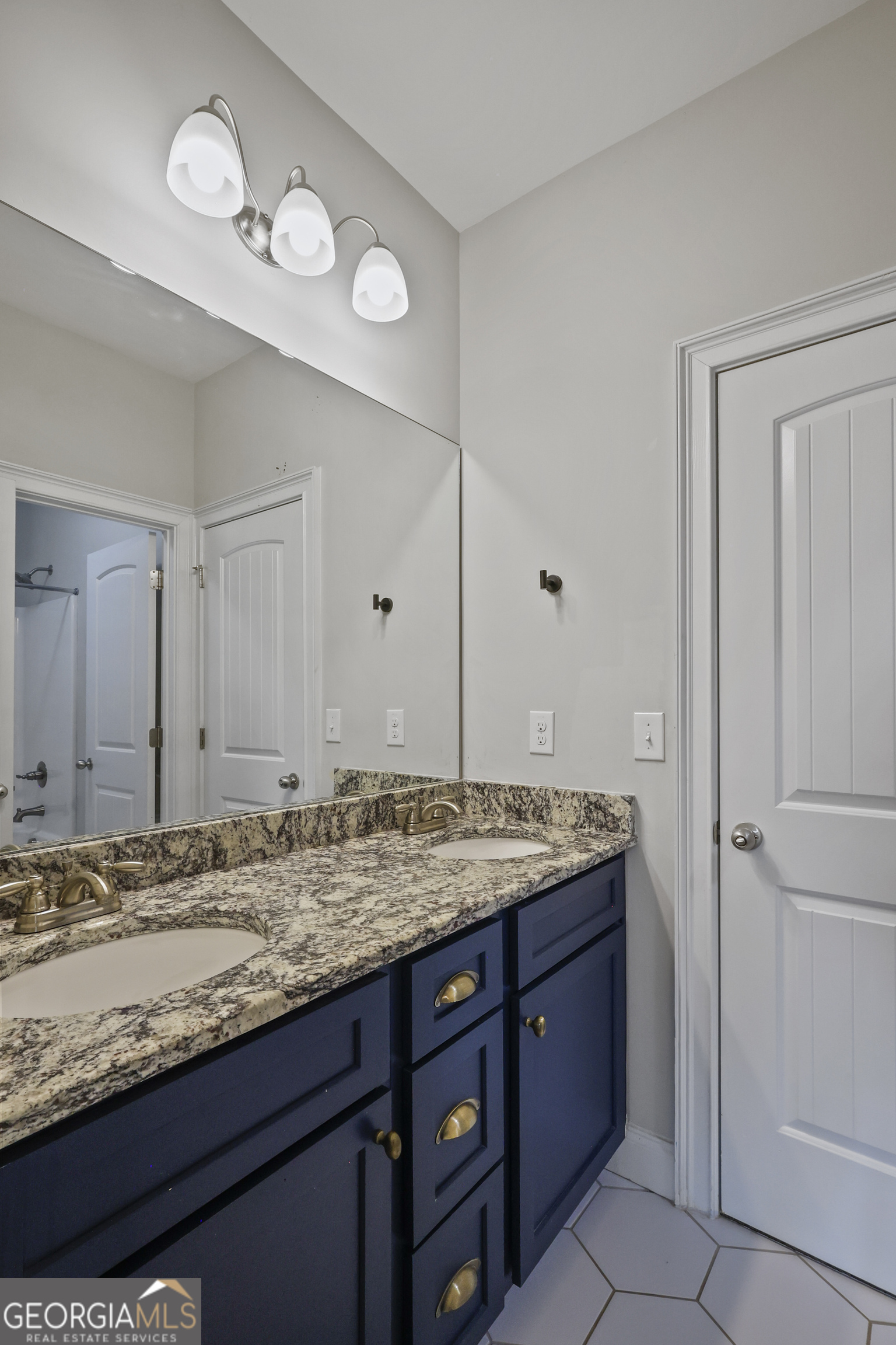 563 Wynn Road McDonough, GA 30252 - Photo 38 of 47 a bathroom with a granite countertop sink and a mirror