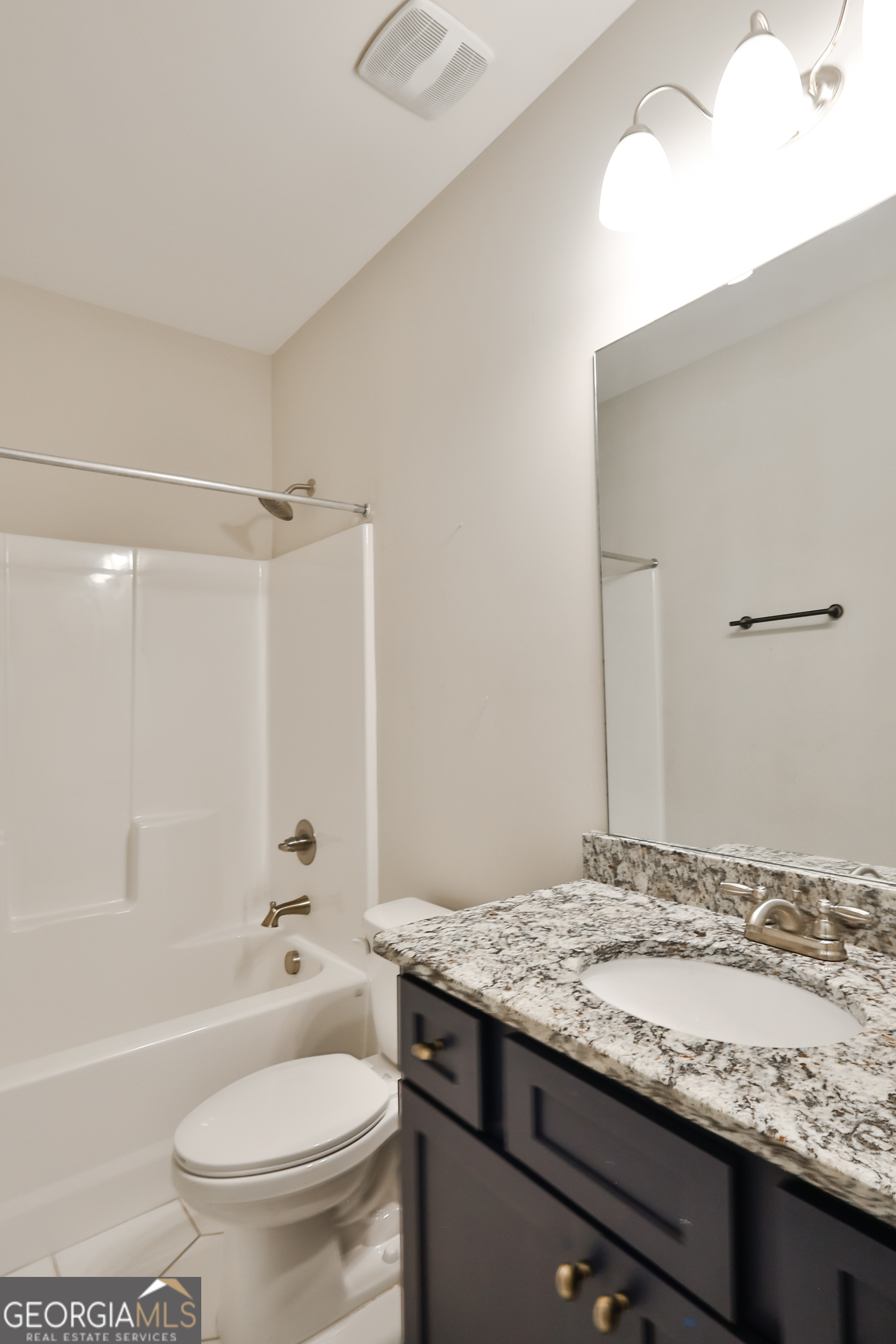 563 Wynn Road McDonough, GA 30252 - Photo 39 of 47 a bathroom with a granite countertop sink toilet and shower