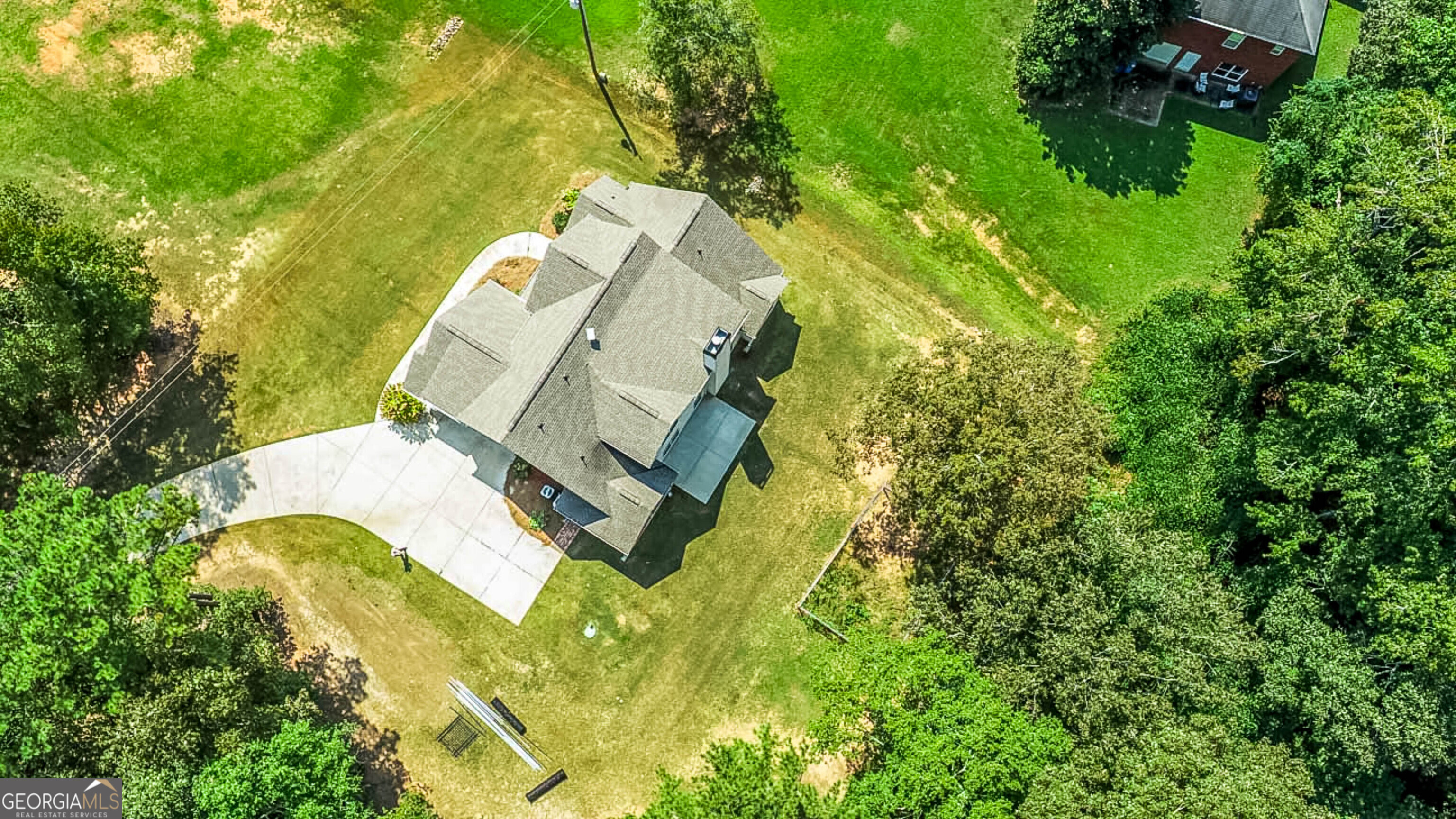 563 Wynn Road McDonough, GA 30252 - Photo 46 of 47 an aerial view of a house with swimming pool and large trees