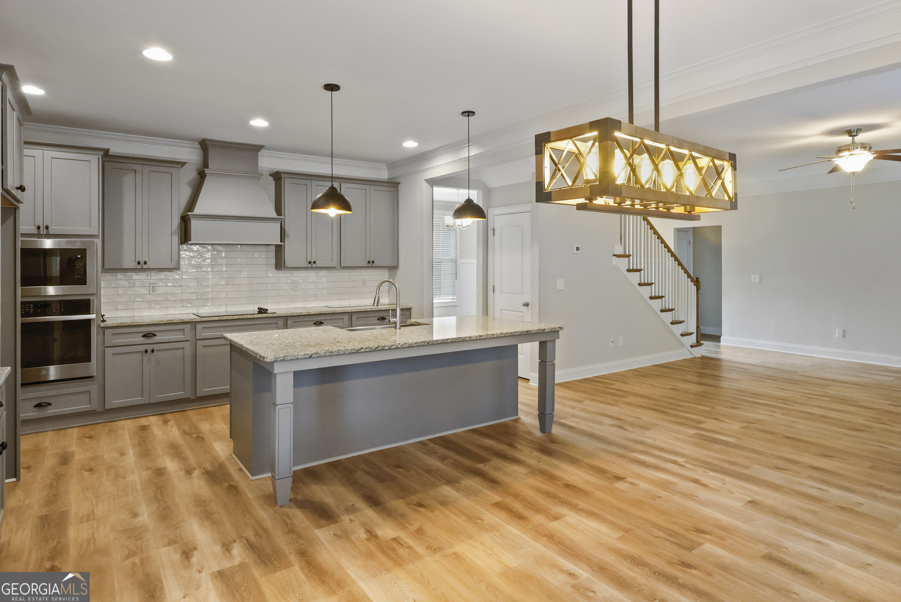 563 Wynn Road McDonough, GA 30252 - Photo 9 of 47 a large kitchen with kitchen island a sink stainless steel appliances and cabinets