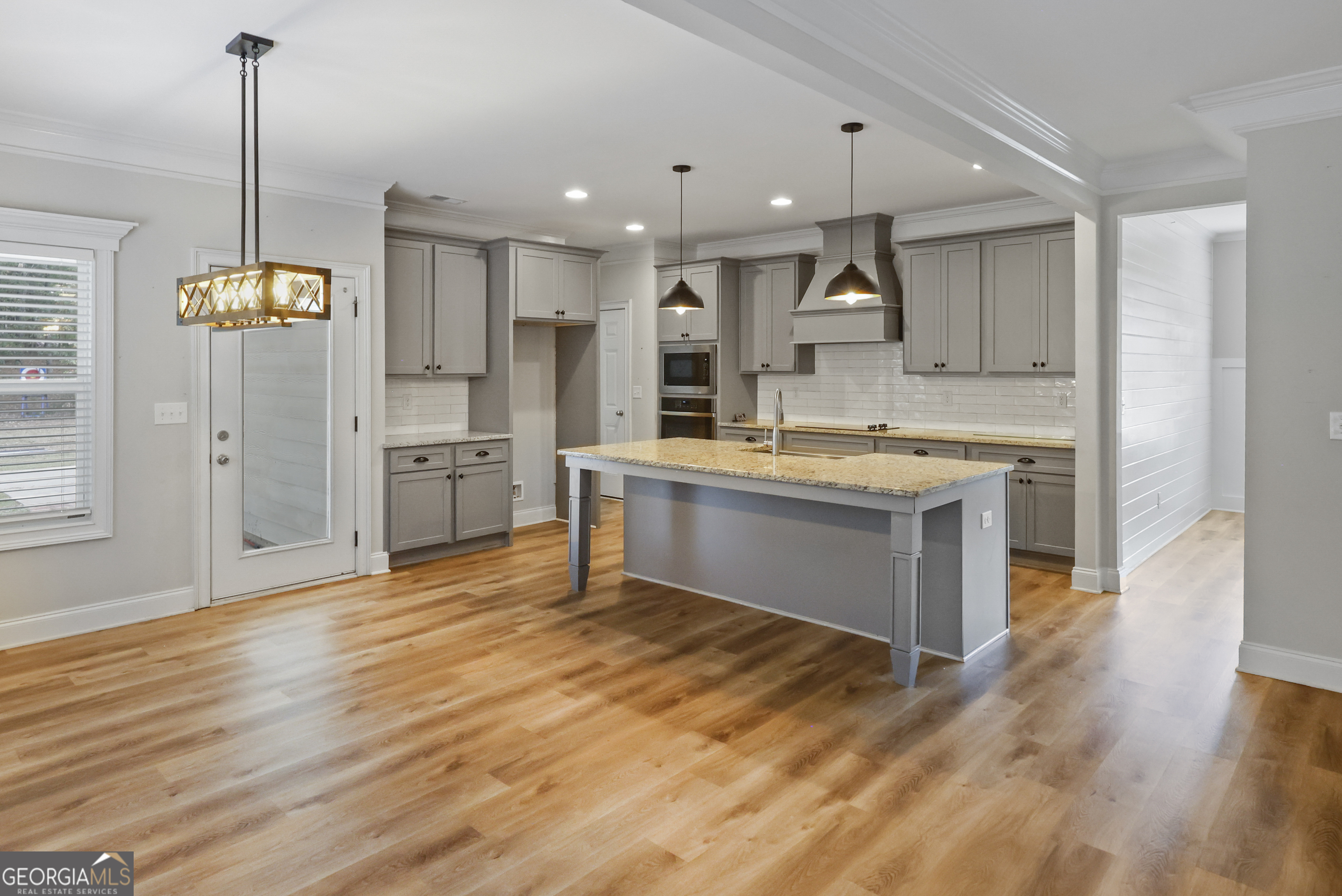 563 Wynn Road McDonough, GA 30252 - Photo 10 of 47 a kitchen with stainless steel appliances kitchen island granite countertop a stove a sink and a refrigerator