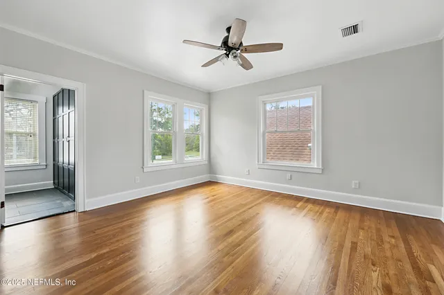 a kitchen with kitchen island granite countertop a sink cabinets and wooden floor