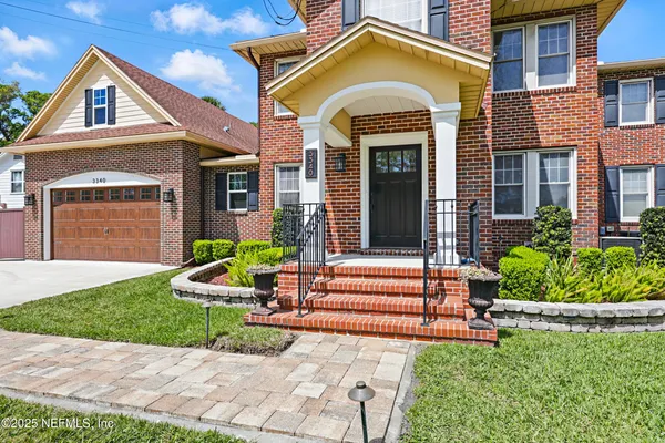 a kitchen with a table chairs refrigerator and microwave