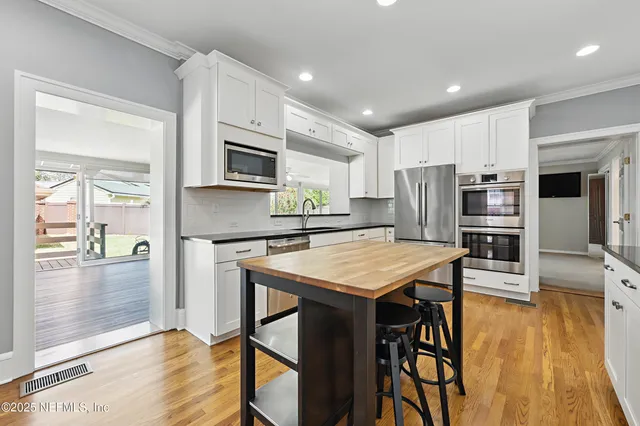a front view of house with yard and trees in the background