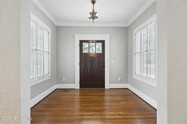 a view of a dining room with furniture and window