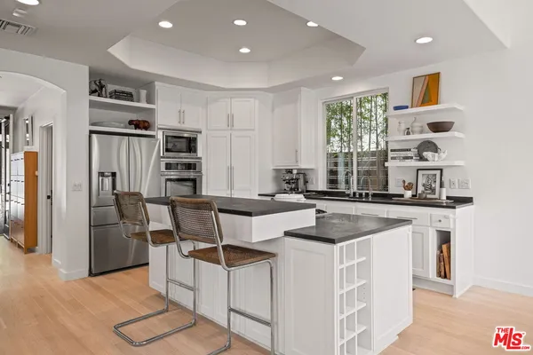 a kitchen with stainless steel appliances granite countertop a stove and a refrigerator