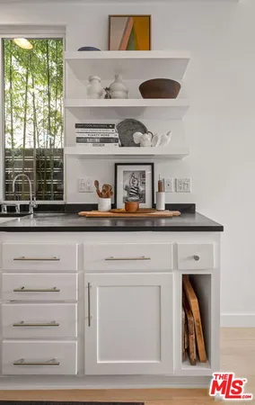a view of white cabinets and a wooden floor