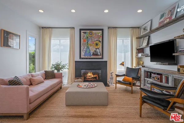a living room with fireplace furniture and a flat screen tv