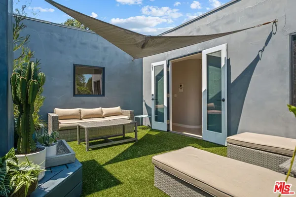 a backyard of a house with outdoor seating