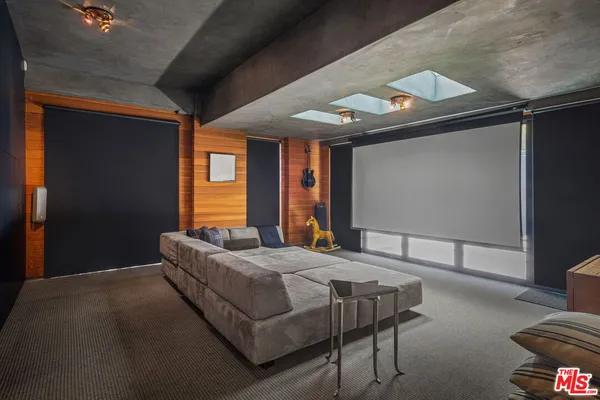 a bedroom with a bed and a dresser next to a window