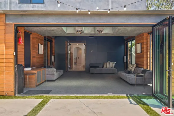 a view of a patio with dining table and chairs