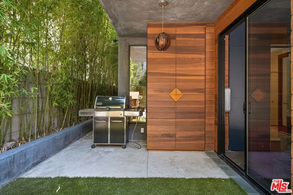 a view of balcony with a table and chairs