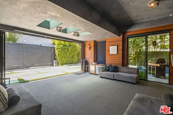 a living room with furniture and large windows