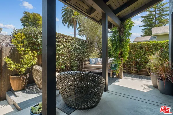 a view of a chairs and table in the patio