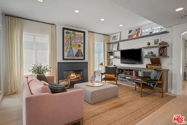 a living room with fireplace furniture and a flat screen tv