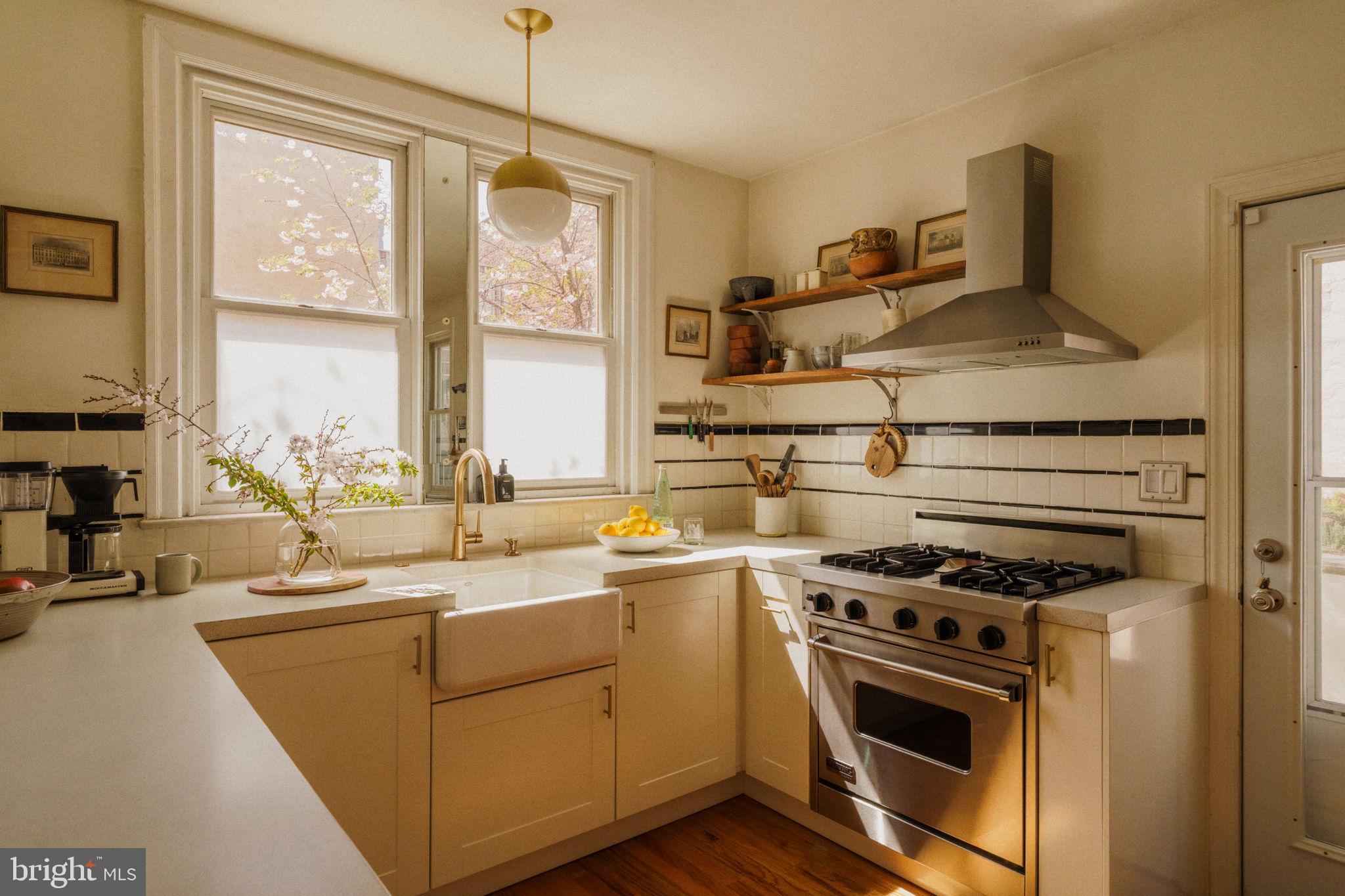 1828 South 9th Street Philadelphia, PA 19148 - Photo 20 of 83 a kitchen with a stove a sink and a microwave