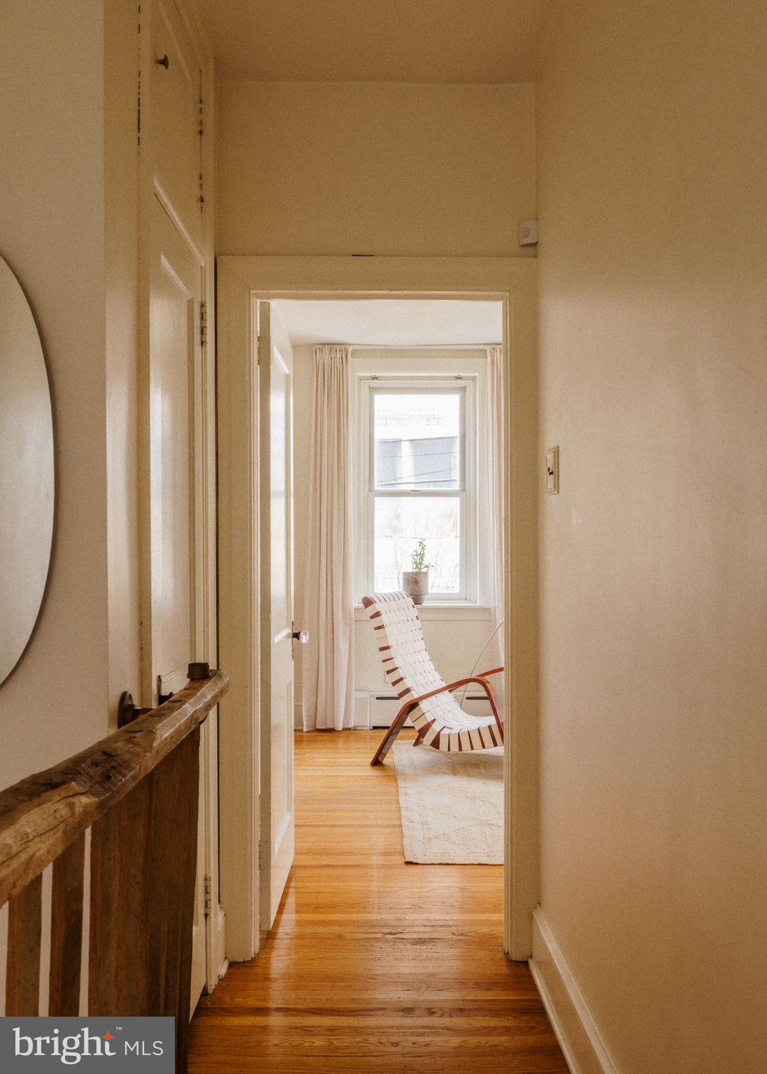 1828 South 9th Street Philadelphia, PA 19148 - Photo 44 of 83 a view of a hallway with wooden floor and a bathroom