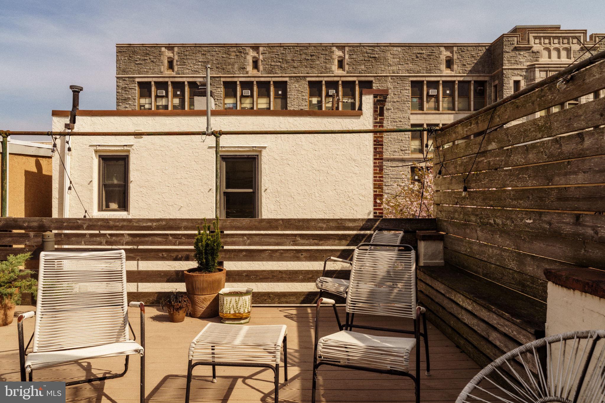 1828 South 9th Street Philadelphia, PA 19148 - Photo 60 of 83 a view of a balcony with two chairs and a barbeque