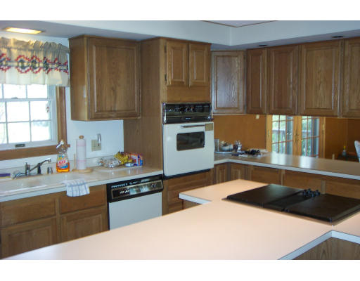528 Cronin Road Warren, MA 01585 - Photo 8 of 13 a kitchen with stainless steel appliances a sink a stove a refrigerator cabinets and a window