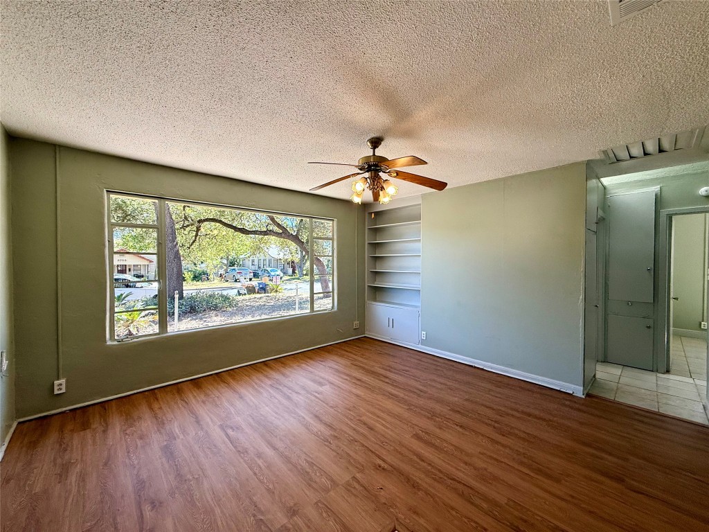 3702 Werner Avenue Austin, TX 78722 - Photo 3 of 20 an empty room with wooden floor fan and windows