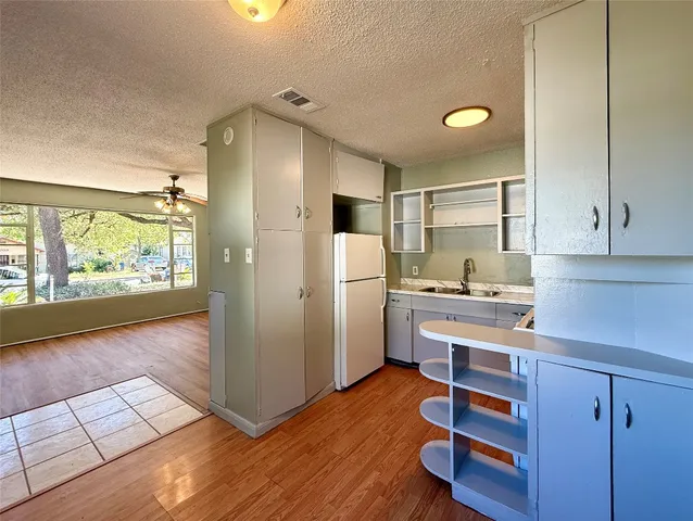 a kitchen with a stove a sink and a refrigerator