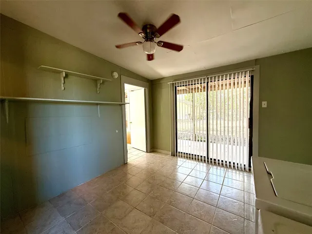 a view of a livingroom with a ceiling fan and window